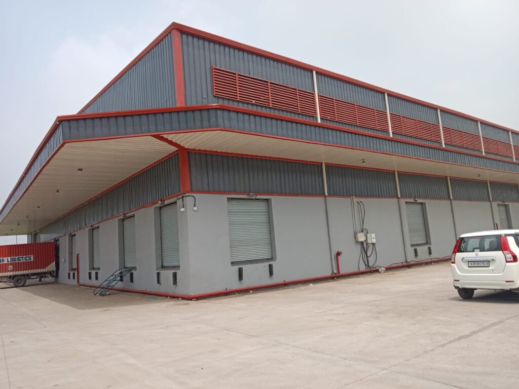 Pre-engineered steel building with red trim and louvers built by Mahawar Prefab Solutions